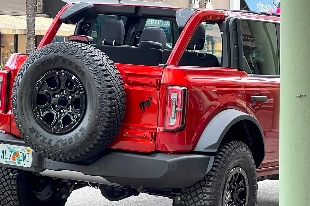 Red Ford Bronco next to the beach