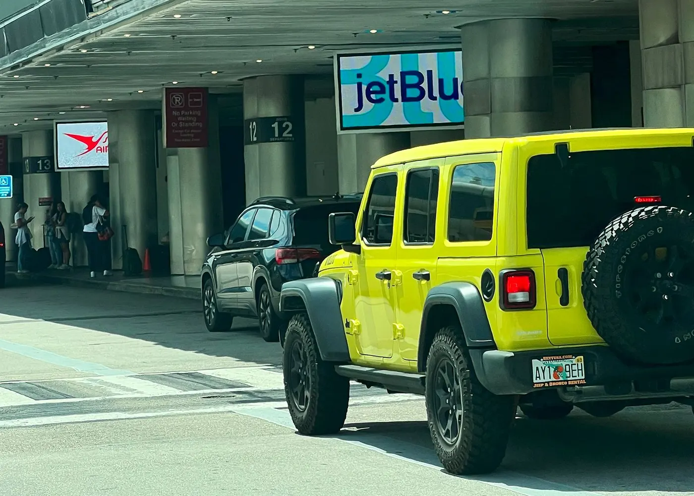 Jeep Wrangler waiting at the curb outside the Fort Lauderdale airport terminal